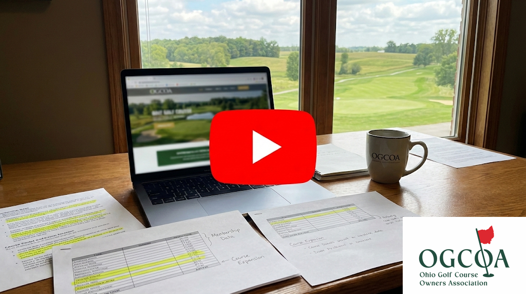 A realistic, high-quality featured image for a video series. Show an office desk with a laptop displaying a blurred golf course website and a visible YouTube-style play button overlay on the laptop screen.